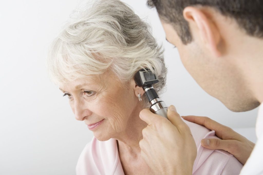 doctor examining a patient with an otoscope